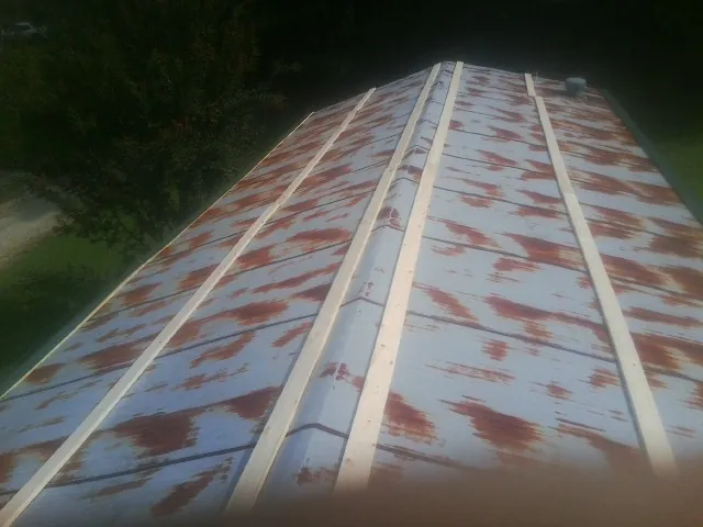 Rusted metal roof panels with new wood purlins before replacement — Storm Damage Roof Repair in New Matamoras by Roofing Brothers