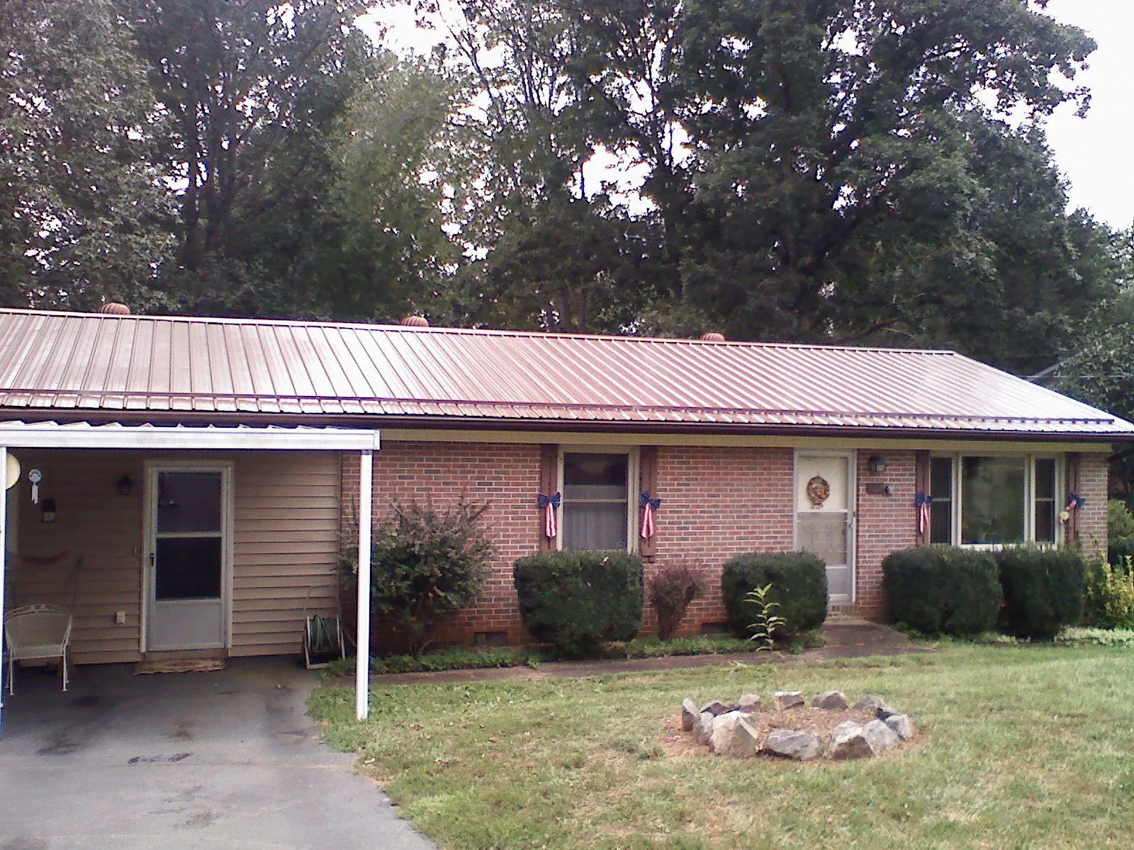 Bronze metal roof and carport on a brick ranch home — Roof Repair work by our crew in New Matamoras